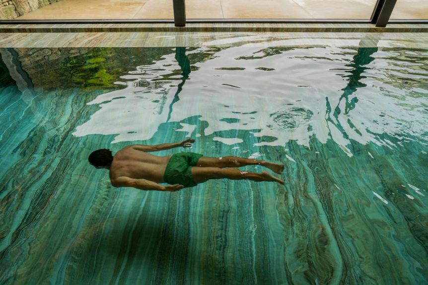 A man floating in a pool of water