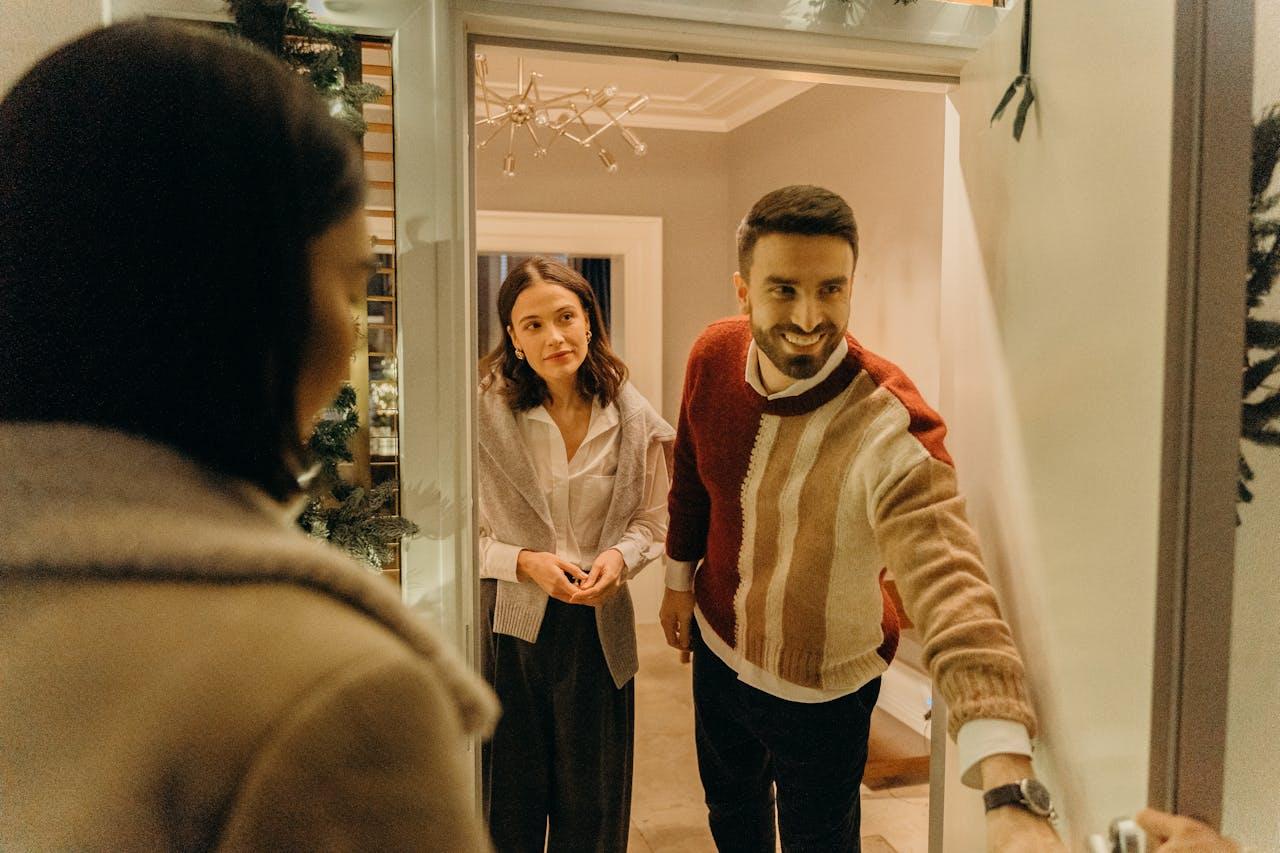 Smiling man opening the door