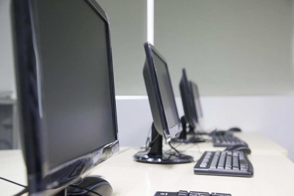Several computers on a desk.