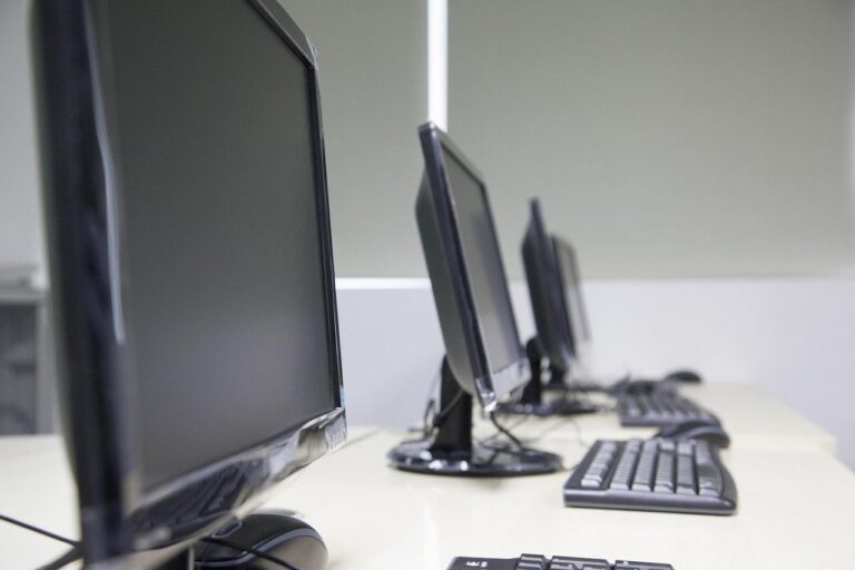 Several computers on a desk.